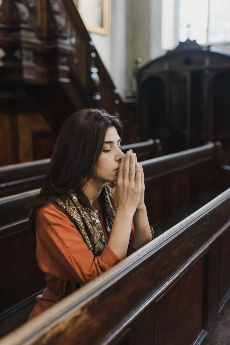 Woman praying in church